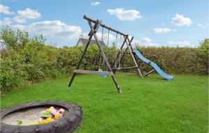 a playground with a tire and a swing at Stunning Home In Glesborg With Wifi in Bønnerup Strand