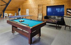 a room with two pool tables and a couch at Stunning Home In Eidsberg With Kitchen 