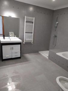 a bathroom with a sink and a toilet and a tub at Casa com Alma by LovelyStay in Fátima +28 photos