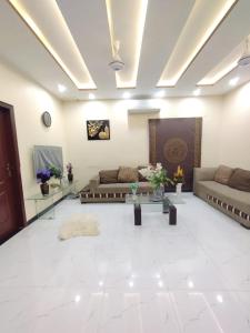a living room with two couches and a table at Dream home 2 & 4 bedroom Family house in Karachi