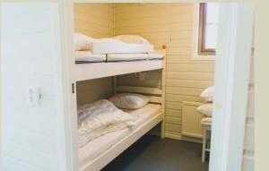 a room with two bunk beds with towels and pillows at Mösseberg Camping in Falköping