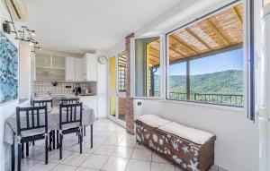 a kitchen with a table and chairs and a large window at Casa Relax In Collina in Castiglione Chiavarese