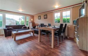 a living room with a table and a couch at Nice Home In Heinkenszand With Wifi in Heinkensand +19 photos