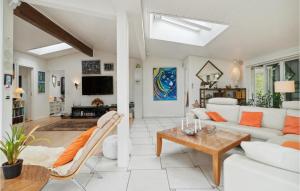 a living room with a white couch and a table at Awesome Home In Asns With Wifi in Asnæs