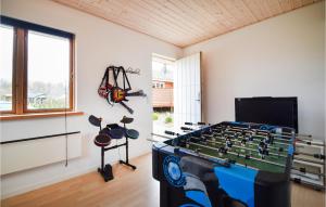 a living room with a foosball table in a room at Beautiful Home In Frvang With 3 Bedrooms, Wifi And Outdoor Swimming Pool in Fårvang