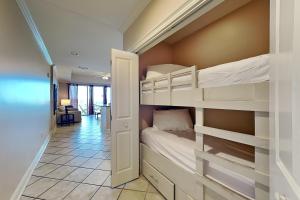 a bedroom with bunk beds in a room at Wharf #506 in Orange Beach