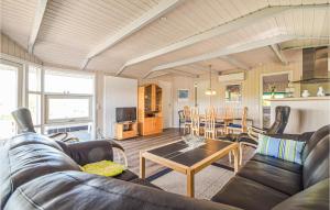 a living room with a couch and a table at Beautiful Home In Brkop With 3 Bedrooms, Sauna And Wifi in Brejning