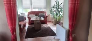 a living room with a chair and a table at Ferienwohnung Gohlke in Stralsund