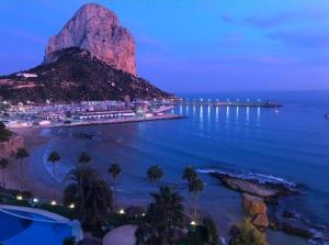 a view of a mountain in the ocean at night at Apartamento Calpe Beach in Calpe