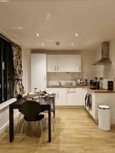 a kitchen with a table and a dining room at Charming studio in Bricklane in London