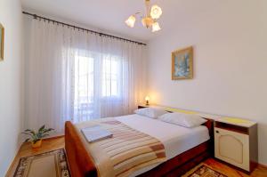 a bedroom with a bed and a large window at Apartman Erika in Senj +38 photos