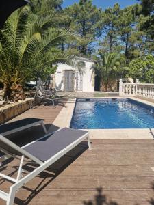 una piscina con un sillón junto a ella en Bonita casa en el bosque - El Tiemblo, en El Tiemblo