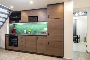 a kitchen with wooden cabinets and a stove at Dessewffy Premium Apartment in Budapest