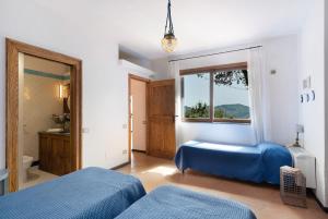 a bedroom with two beds and a window at Dependance in Costiera Amalfitana in Cava deʼ Tirreni