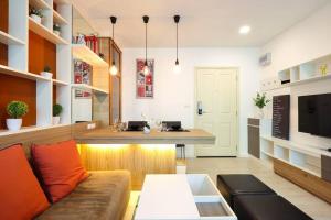 a living room with a couch and a table at Greenery living in resort condo in Chiang Mai