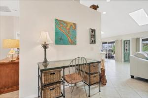 a room with a desk with a chair and a lamp at 2101 SE 2nd Terr in Cape Coral