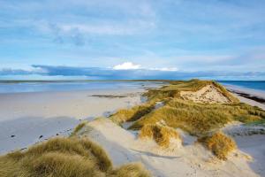 an island in the sand on a beach at Orkney Retreats 1 2 and 3 bedroom Island Farmhouses & Cottages in Sanday