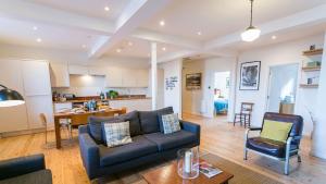 a living room with a couch and a table at Capel Seion in Aberffraw