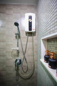 a shower in a bathroom with a blow dryer at Luxury Living in heart of Nimman in Chiang Mai