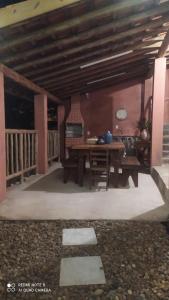 a patio with a wooden table and a table at Casa Europeia em Cunha in Cunha