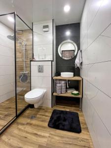 a bathroom with a toilet and a shower and a sink at SOS CoMFORT 2 LAZUR in Burgas