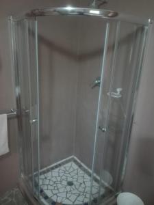a shower with a glass enclosure in a bathroom at Emerald Hill Cottage in Mount Pleasant