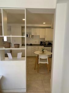 a kitchen with a table and a table and chairs at Cony Lee Esteco in Salta