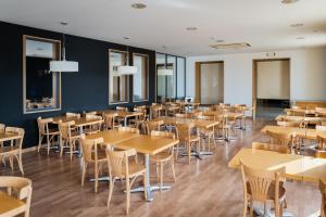 a dining room with wooden tables and chairs at AS Chucena in Chucena