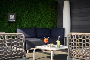 a patio with a couch and two chairs and a table at Catalonia Born in Barcelona +33 photos