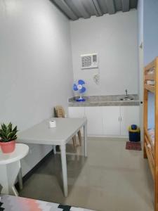 a white kitchen with a table and a sink at COSTA DE ANGELO BOLO BEACH RESORT in Alaminos