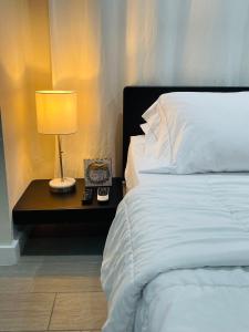 a bedroom with a bed and a lamp on a table at Nuvole Guest Suite in Miami