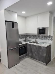 a kitchen with a stainless steel refrigerator and sink at Apartamento pet-friendly en Atocha by beBalmy in Madrid