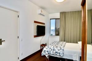 Ένα ή περισσότερα κρεβάτια σε δωμάτιο στο Copacabana Vista Mar