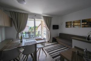 a living room with a couch and a table at Apartments Villa Rivarella in Novigrad Istria