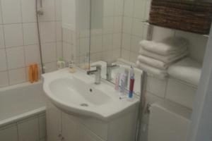 W łazience znajduje się umywalka i lustro. w obiekcie Private Rooms w Hanowerze
