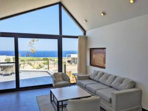 a living room with a couch and a table at Sea & Golf Views 2BR Villa with Free Beach & Pool Access in Hurghada