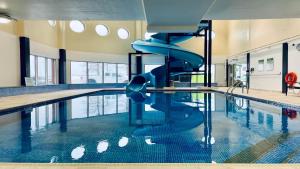 a swimming pool with a slide in the middle of it at Holiday Inn Sydney - Waterfront, an IHG Hotel in Sydney