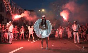 a group of people standing in the street with flares at Apartman Erika in Senj