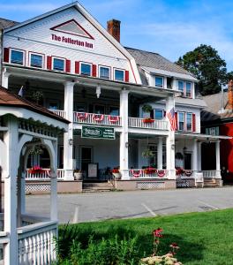 a white inn with an american flag in front of it at Fullerton Inn & Restaurant in Chester