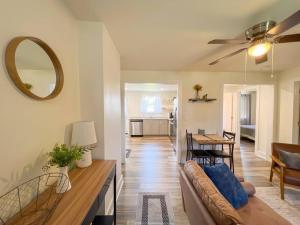 a living room with a couch and a table at 2BR Cedar Lane Road Retreat at Swamp Rabbit Trail! in Greenville