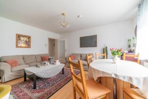 a living room with a table and a couch at Private Apartment in Hannover