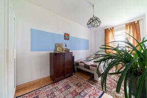 a bedroom with a bed and a potted plant at Private Apartment in Hannover