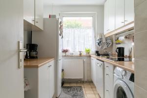 a kitchen with a white refrigerator and a window at Private Apartment in Hannover +6 photos