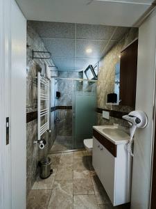 a bathroom with a shower and a sink and a toilet at Punta Vista Hotel in İzmir +25 photos
