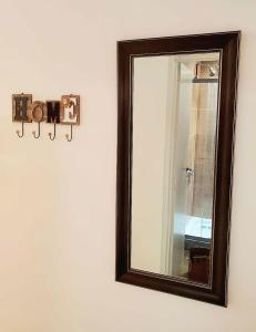 a mirror on a wall with a frame on it at BA Monroe 2 in Buenos Aires
