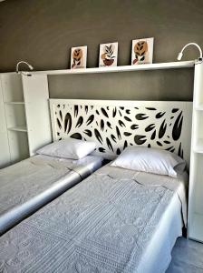 a bedroom with a bed with a headboard and two pillows at BA Monroe 2 in Buenos Aires