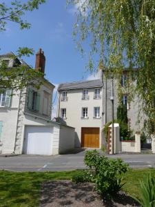 a white house with a garage in front of it at Loire Escale in Ancenis