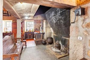 a room with a stone wall with a fireplace at Solar dos Carvalhos in Sernancelhe