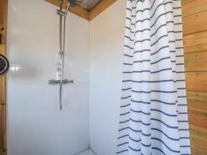 a shower in a bathroom with a shower curtain at The Snug in Dulverton