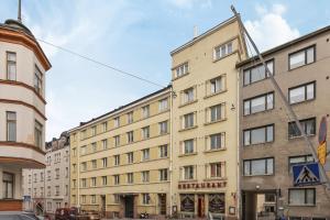 a building in the middle of a street at WeHost Penthouse Studio with Sauna and Balcony @Meritullinkatu 13 A in Helsinki